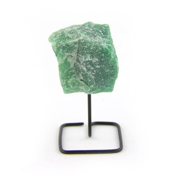 Raw green quartz crystal on black metal display stand, front-facing on white background.